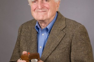 Douglas Engelbart con un prototipo del ratón de computadora en la mano