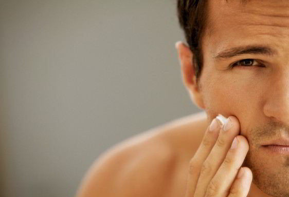 Close-up of young man applying shaving cream