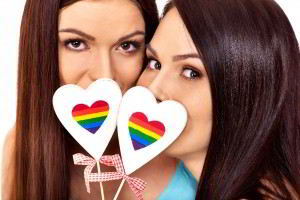Retrato de dos mujeres cada una phylogeneticcon una paleta de corazón con el arcoiris