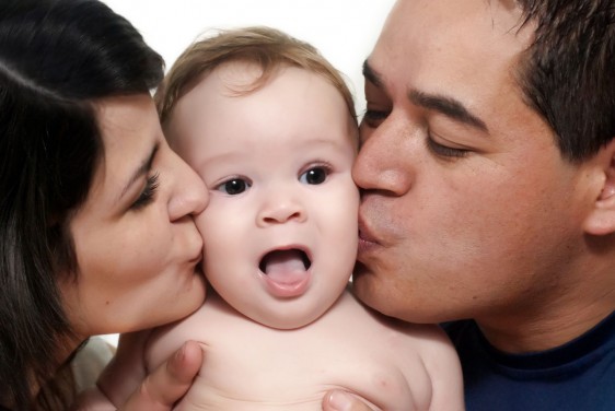 baby with parents on a white background