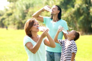 Familia tomando agua en un parque
