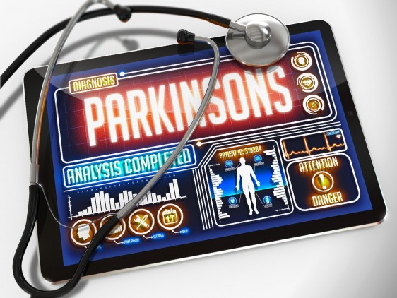 Estetoscopio al lado de una pantalla de computadora con una ilustracipon y la palabra "Parkinsons"