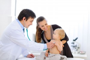 Médico pediatra con un bebé y su madre