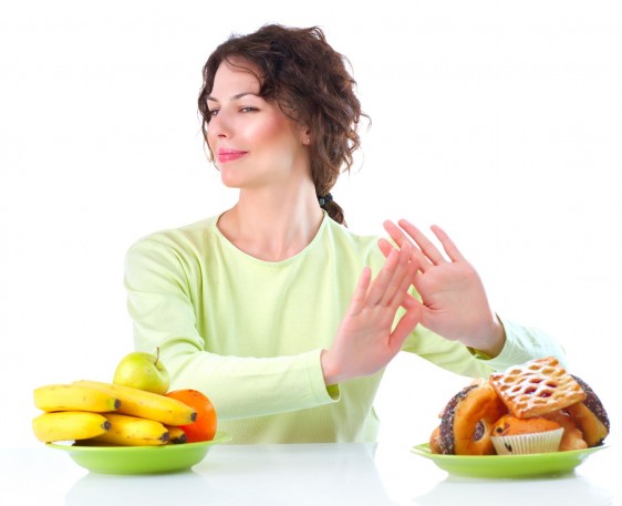 Mujer rechazando productos con alimentos con muchas calorías