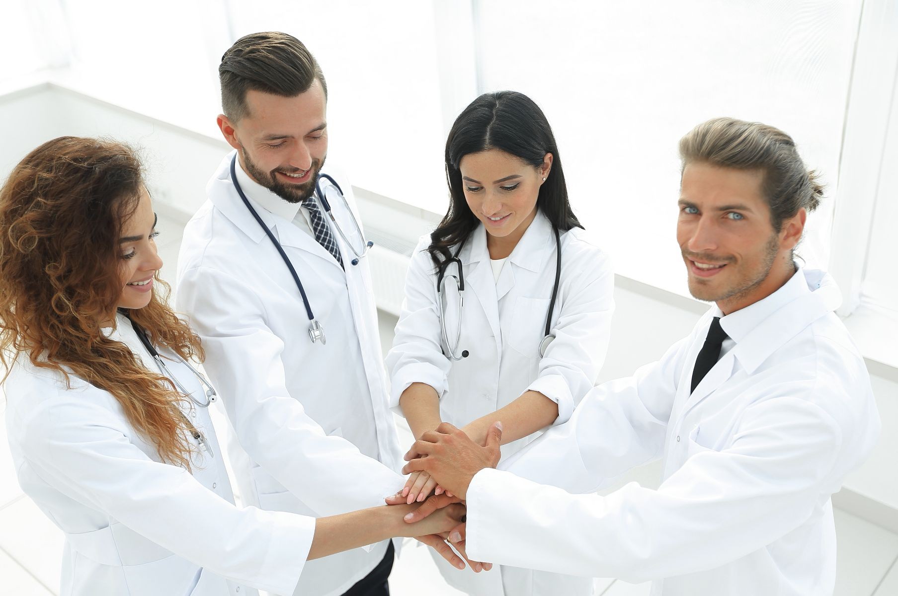 equipo medico juntando manos