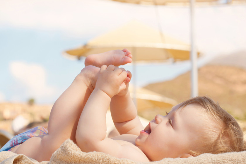 Bebé en la playa tomando rayos de sol