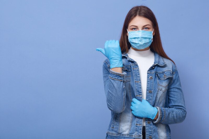 Imagen de una mujer caucásica morena con el pelo largo, usando guantes