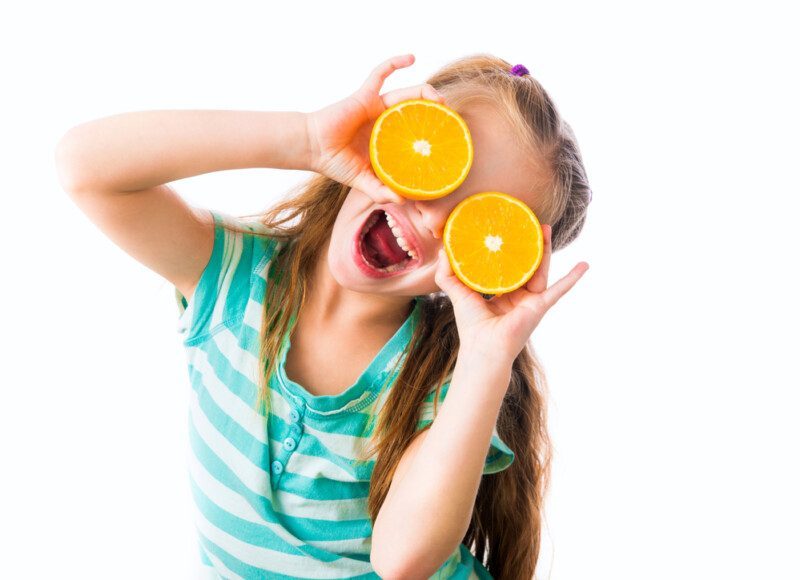 Niña con naranjas