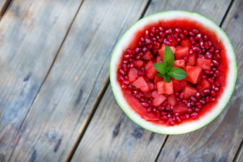 Sandía fresca y jugosa decorada con trozos de corazón y granada — Foto de Stock New Borrar fondo Guardar Compartir Muestra Sandía fresca y jugosa decorada con trozos de corazón y granada