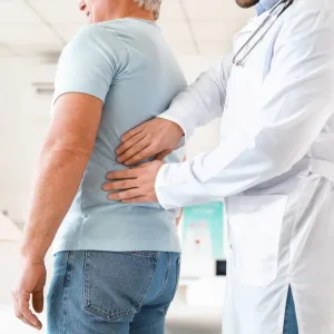 Urologist examining mature patient in clinic